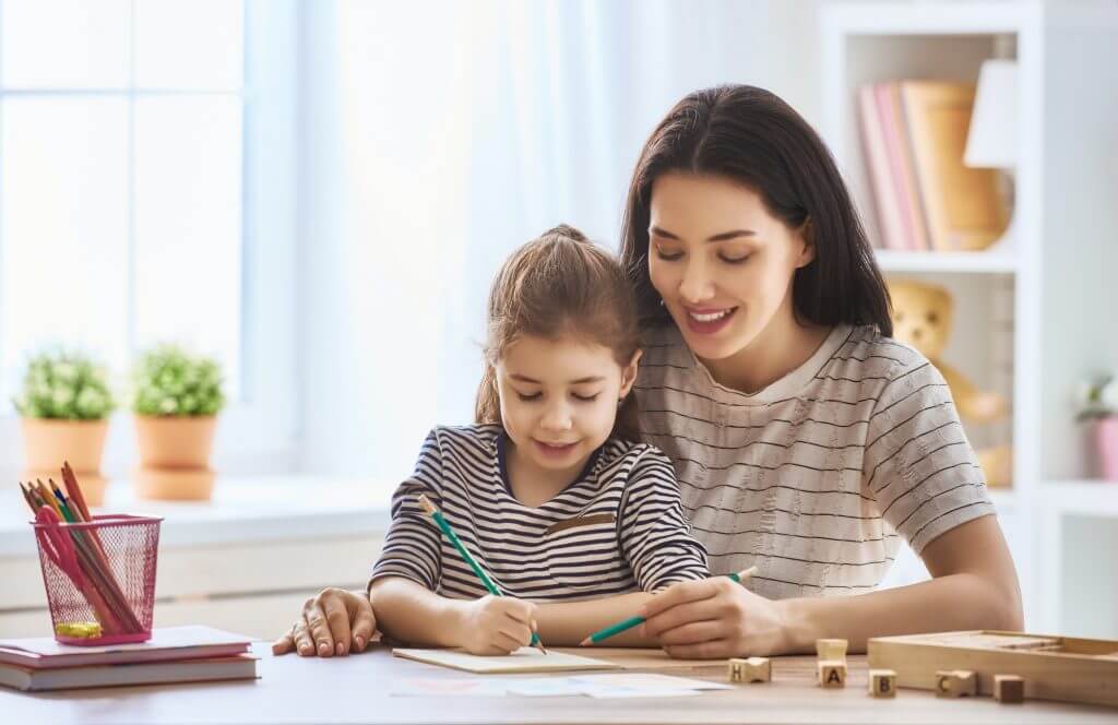 Mother homeschooling daughter in Hong Kong